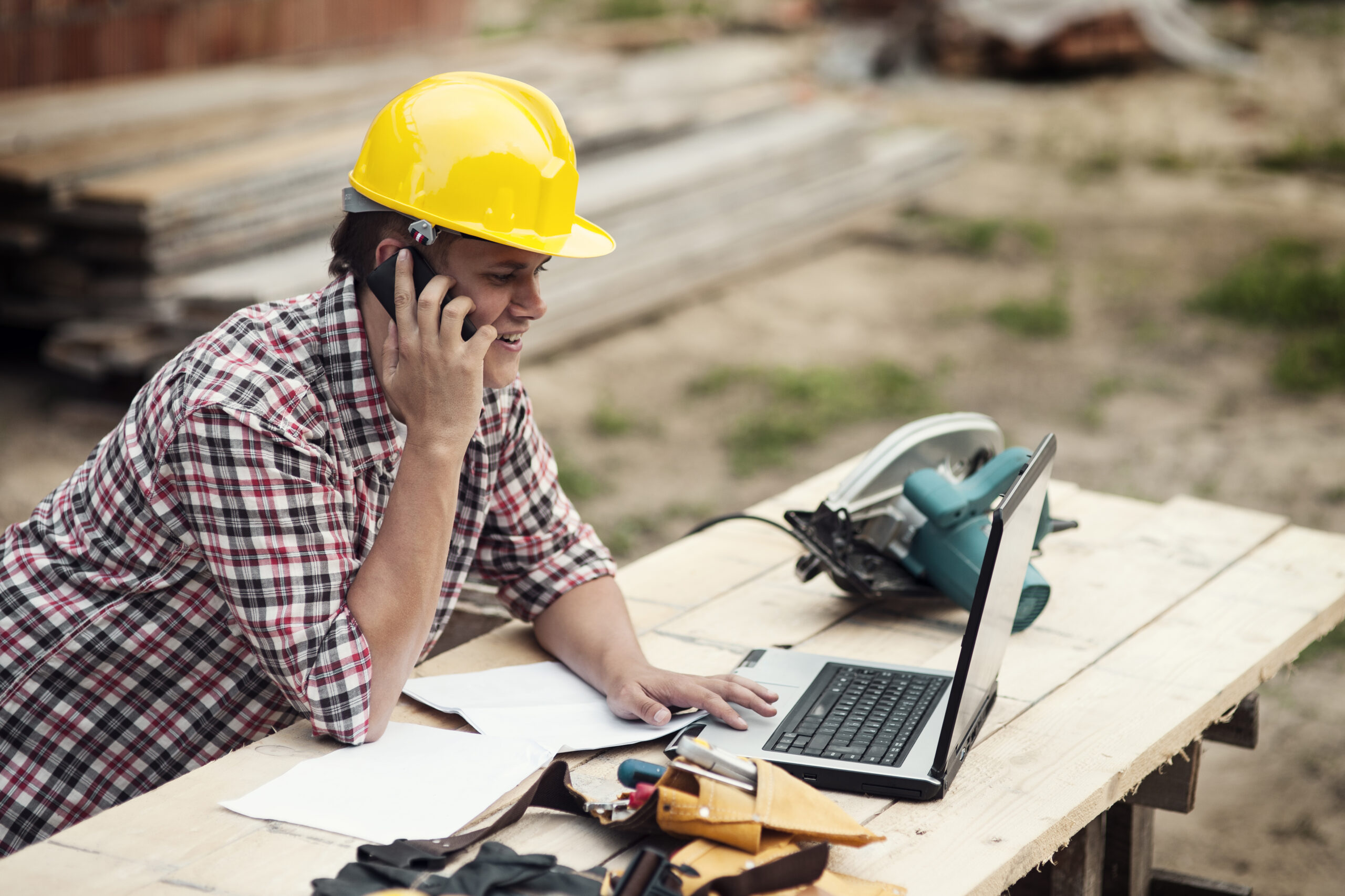 Carpenter talking on mobile phone